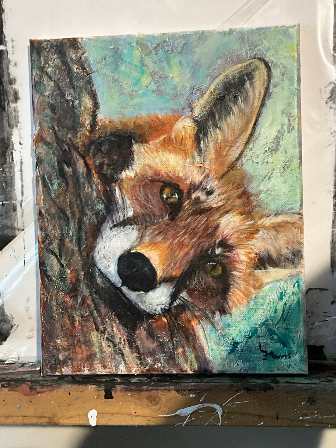 Finished fox painting with a playful, curious expression peeking over a tree.